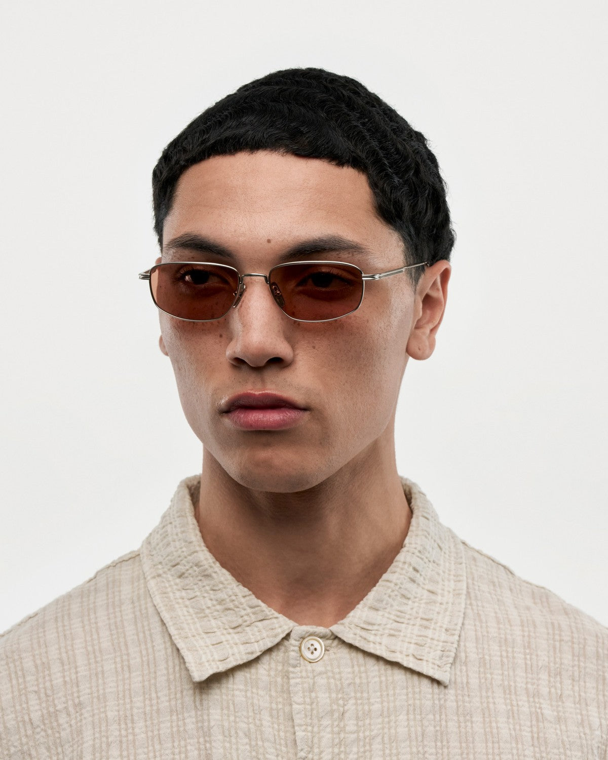 Model wearing CHIMI CC Titan Plane Silver sunglasses in studio.