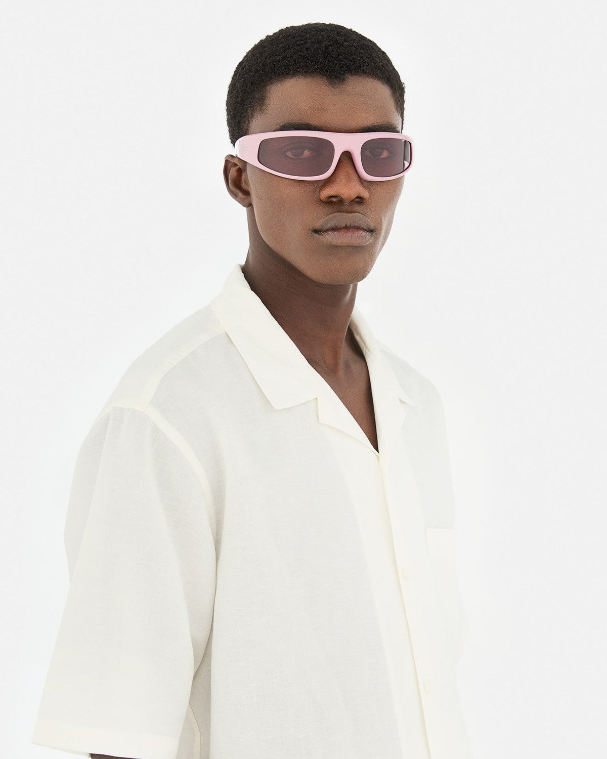 Model wearing RETROSUPERFUTURE Cerchietto Caramella sunglasses in three-quarter view.