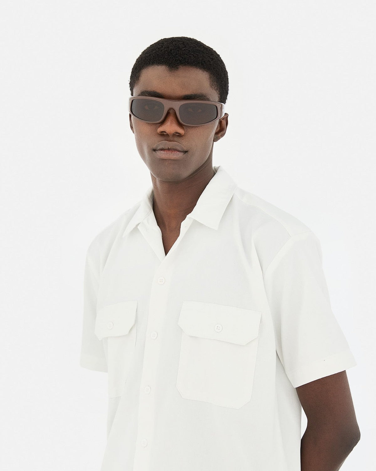 Model wearing RETROSUPERFUTURE Cerchietto Ciambella eyeglasses with white shirt.