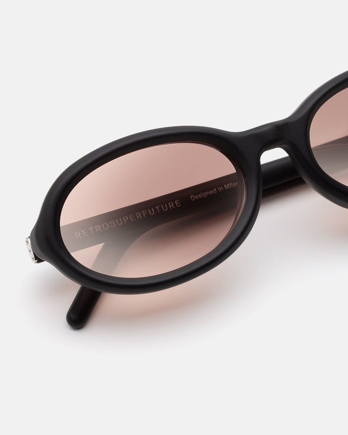 Close-up of the lens and temple detail on RETROSUPERFUTURE Cherry Black Matte sunglasses.