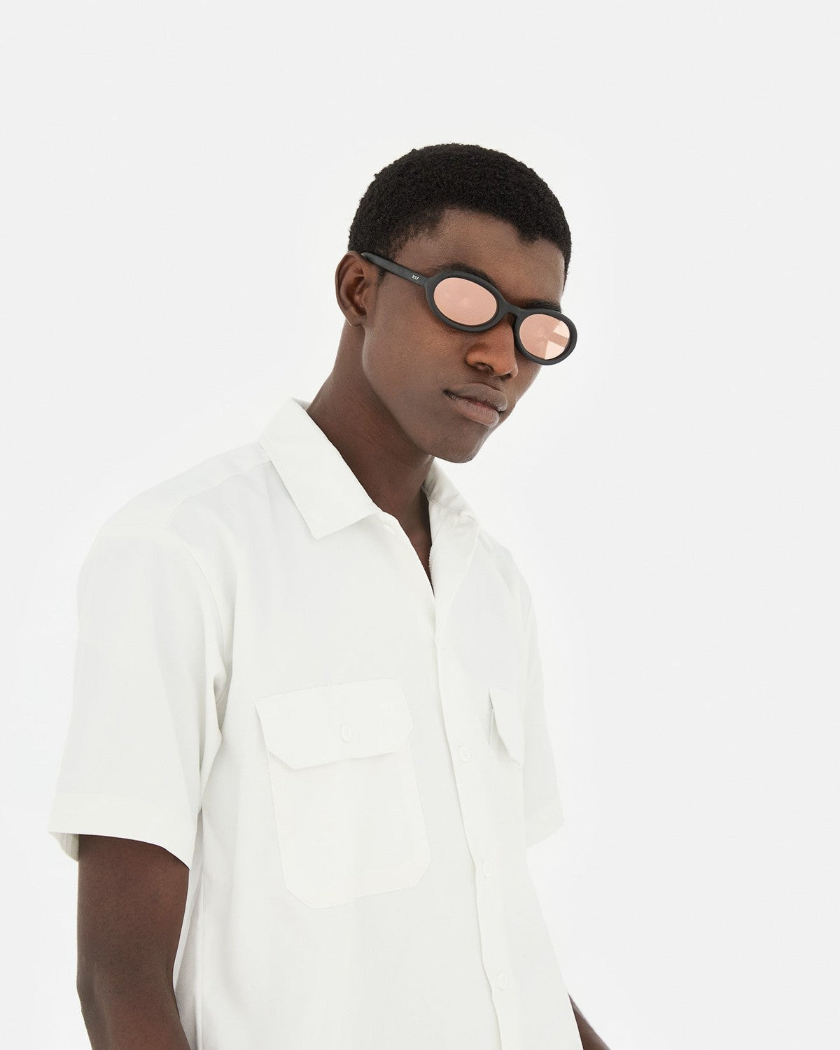 Model wearing RETROSUPERFUTURE Cherry Black Matte sunglasses in side profile.