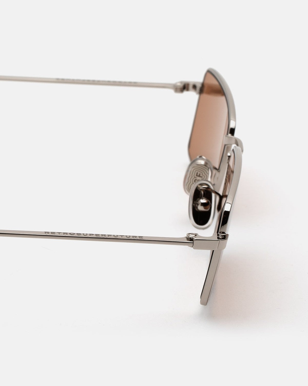 Close-up of the hinge mechanism on RETROSUPERFUTURE Chopper Brown Marble sunglasses.