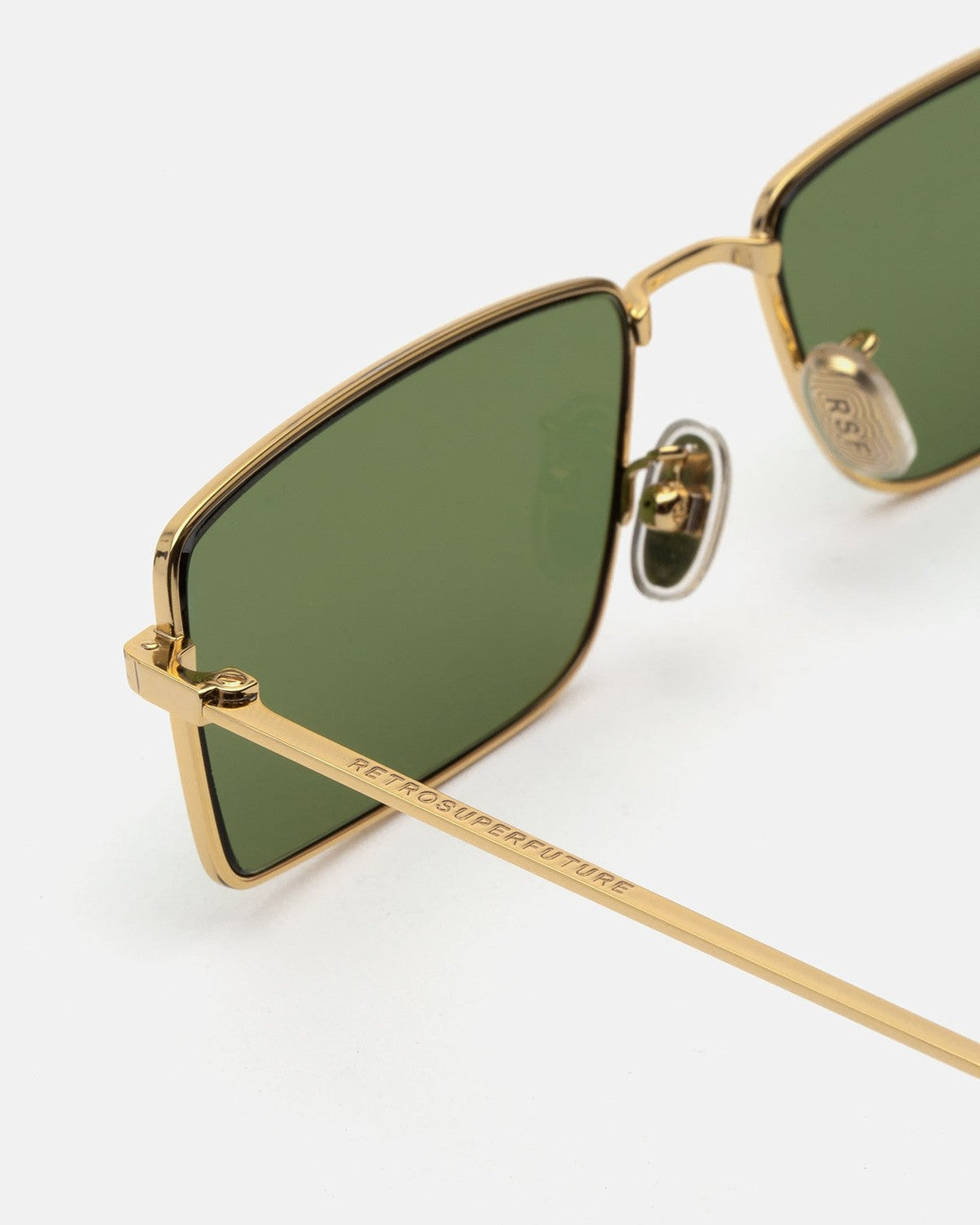 Close-up of the gold metal temple and nose pad on RETROSUPERFUTURE Chopper Light Havana sunglasses.
