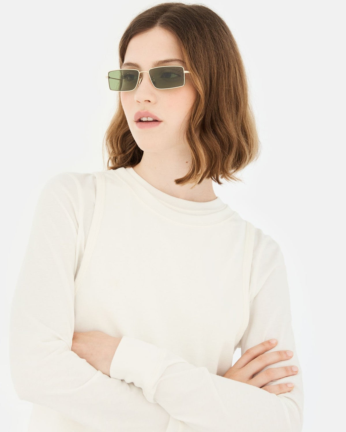 Model wearing RETROSUPERFUTURE Chopper Light Havana sunglasses with arms crossed.