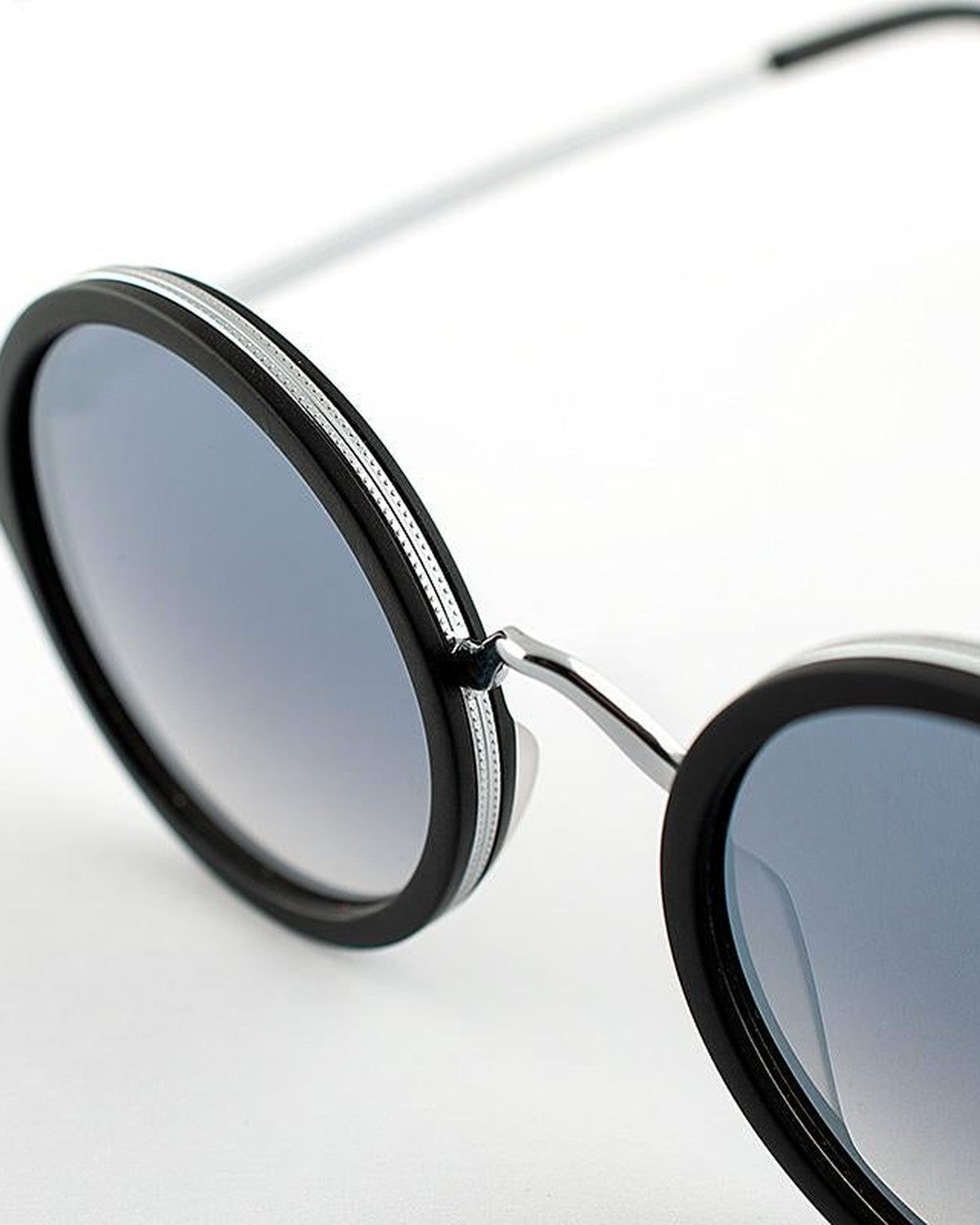 Close-up of the round lens and metal bridge on EYEPETIZER DES ART C.A-1-27F sunglasses.