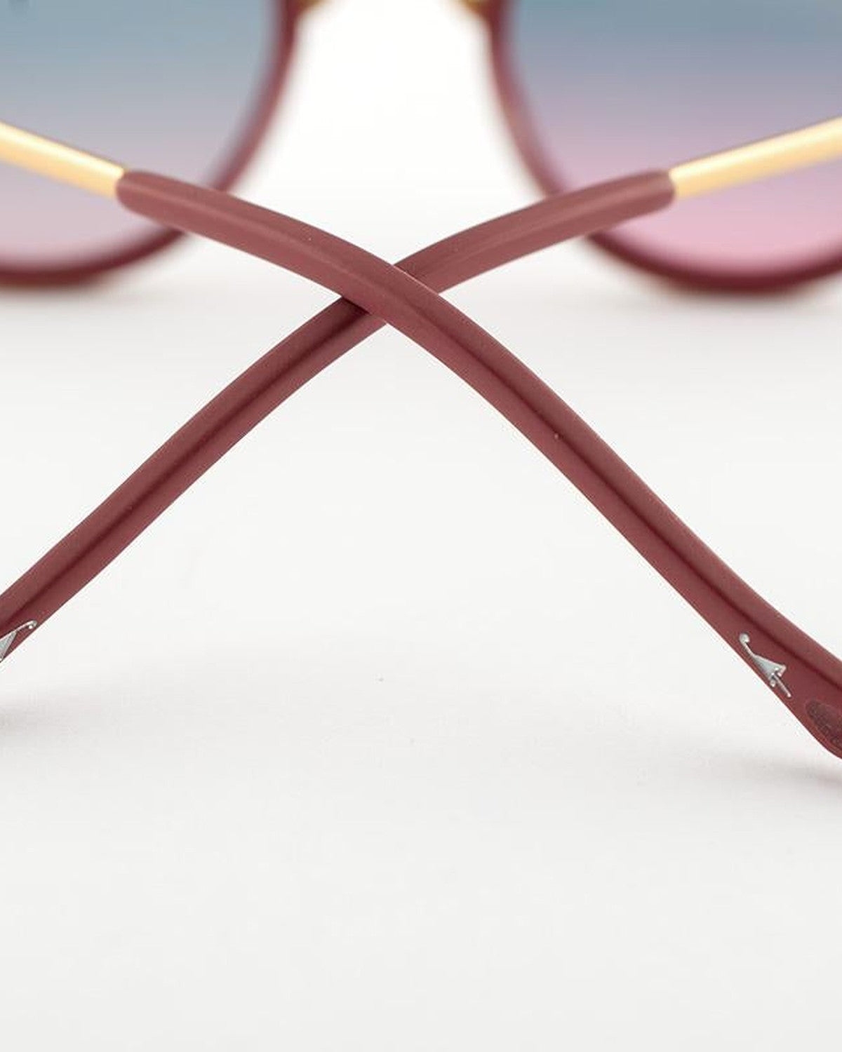 Detail of the crossed temples showing the unique hinge construction of EYEPETIZER DES ART C.O-4-20 sunglasses.