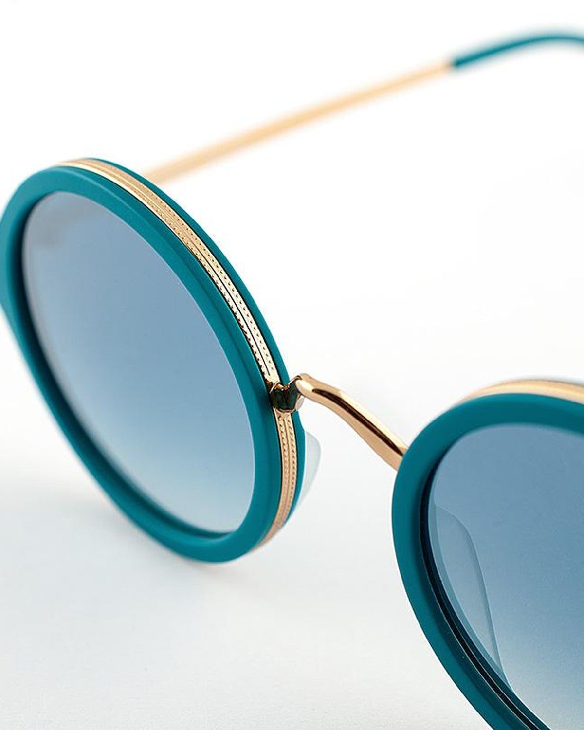 Close-up of the bridge and gold metal accents on EYEPETIZER DES ART C.T-4-26F sunglasses.
