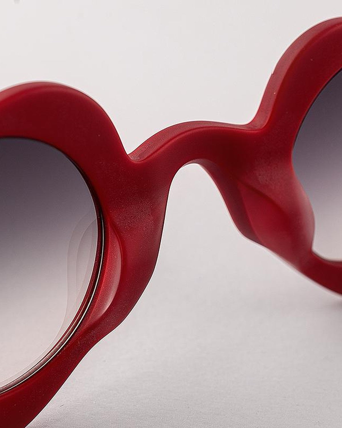 Close-up of the left lens and heart-shaped frame contour on EYEPETIZER DICIASSETTE C.W-27F sunglasses.