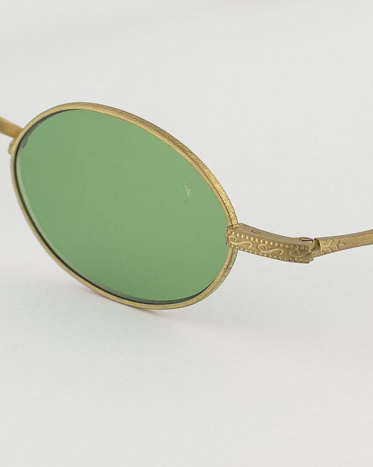 Close-up of the textured temple hinge and oval lens on EYEPETIZER DICKIE C.4-OP-29 sunglasses.