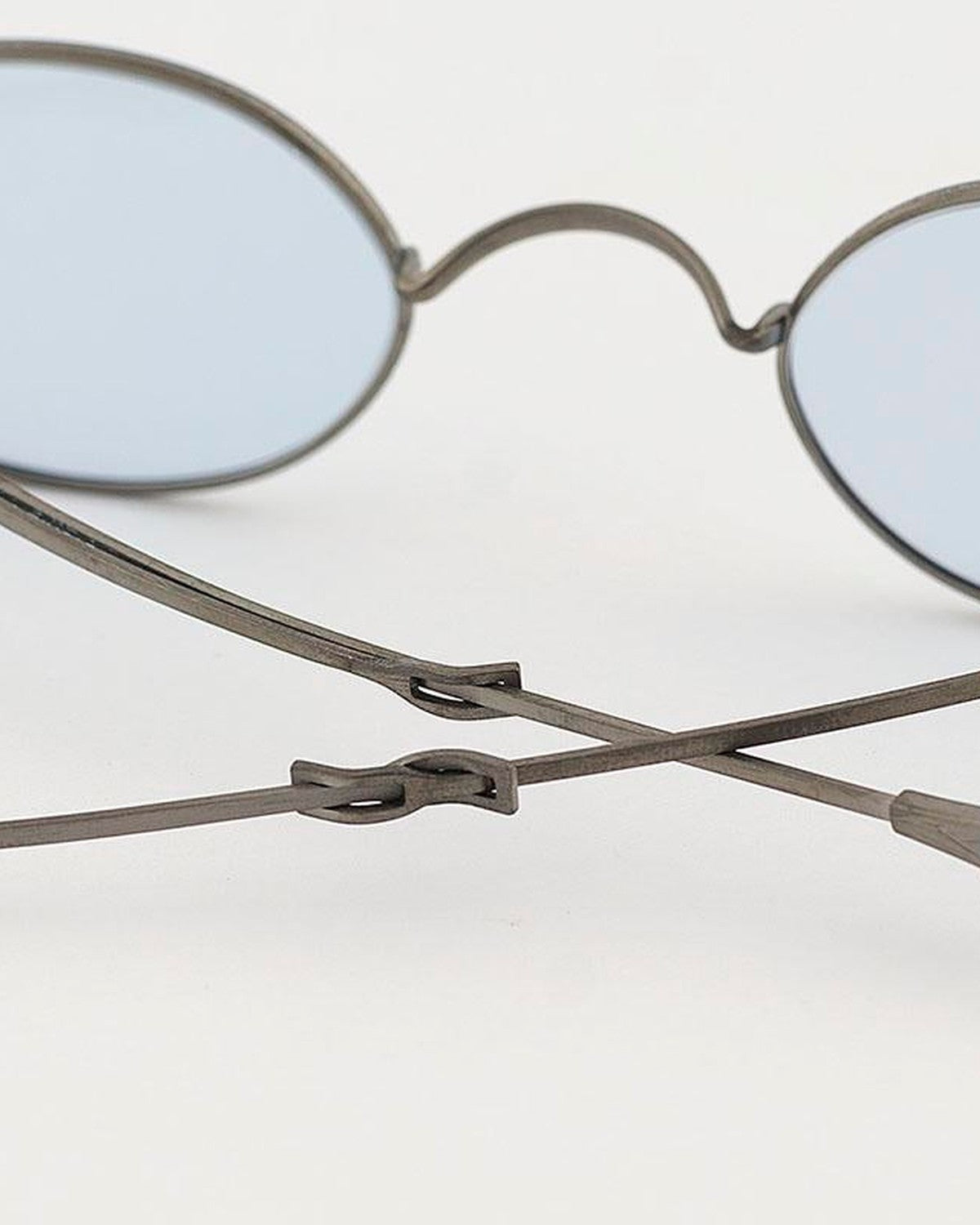 Close-up of the metal temple joint and hinge mechanism on EYEPETIZER DICKIE C.1-OP-2 sunglasses.