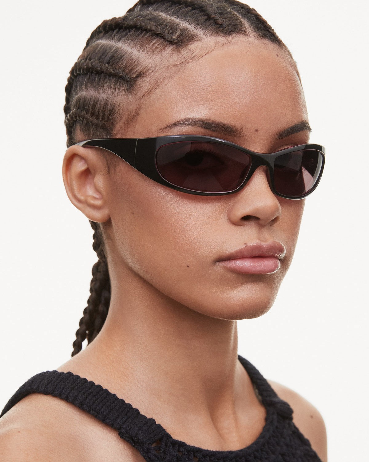 Side profile of model wearing CHIMI Dusk Black Black sunglasses.