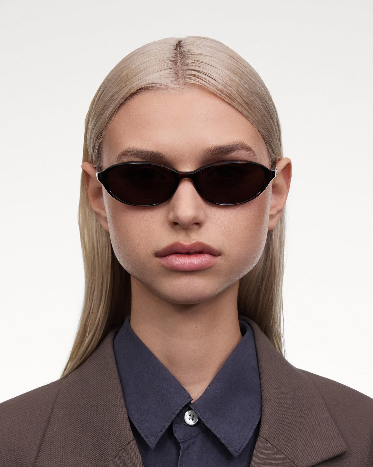 Model wearing CHIMI Ellipse Tortoise Brown sunglasses in front view.