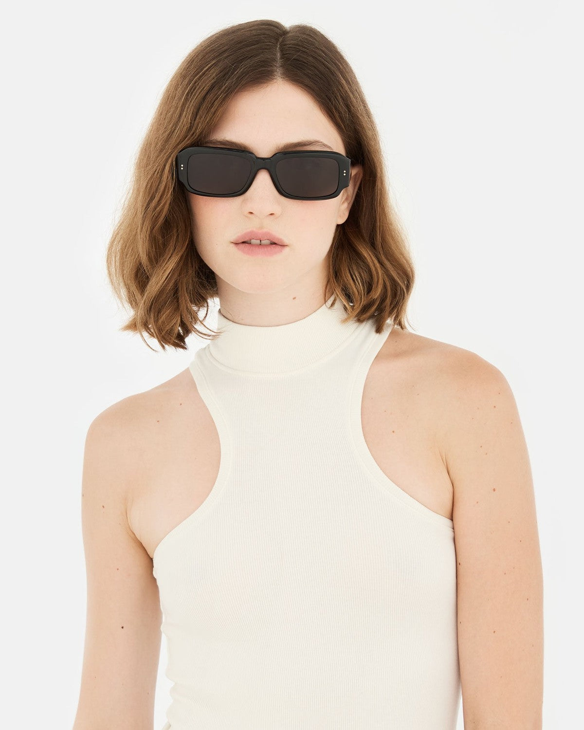 Model wearing RETROSUPERFUTURE Etrusco Black sunglasses with a turtleneck.