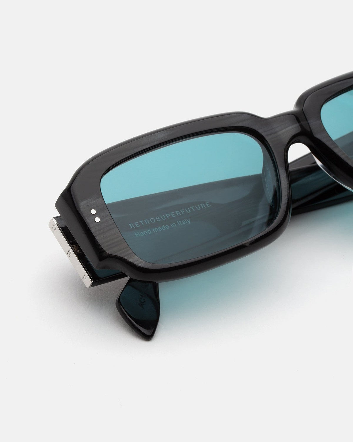 Close-up of the temple and textured frame detail on RETROSUPERFUTURE Etrusco Fiammato sunglasses.