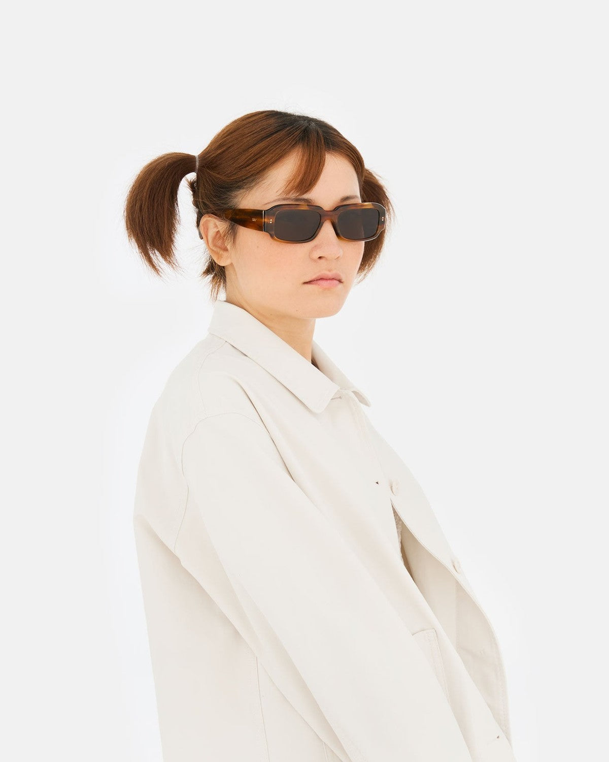 Model wearing RETROSUPERFUTURE Etrusco Tangeri sunglasses in profile.