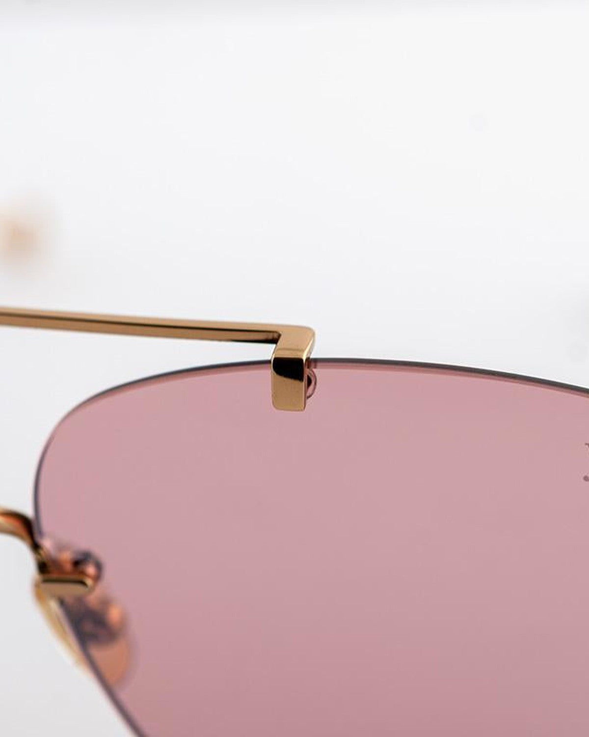 Detail of the gold nose bridge hardware on EYEPETIZER FLOW C.4-28 sunglasses.