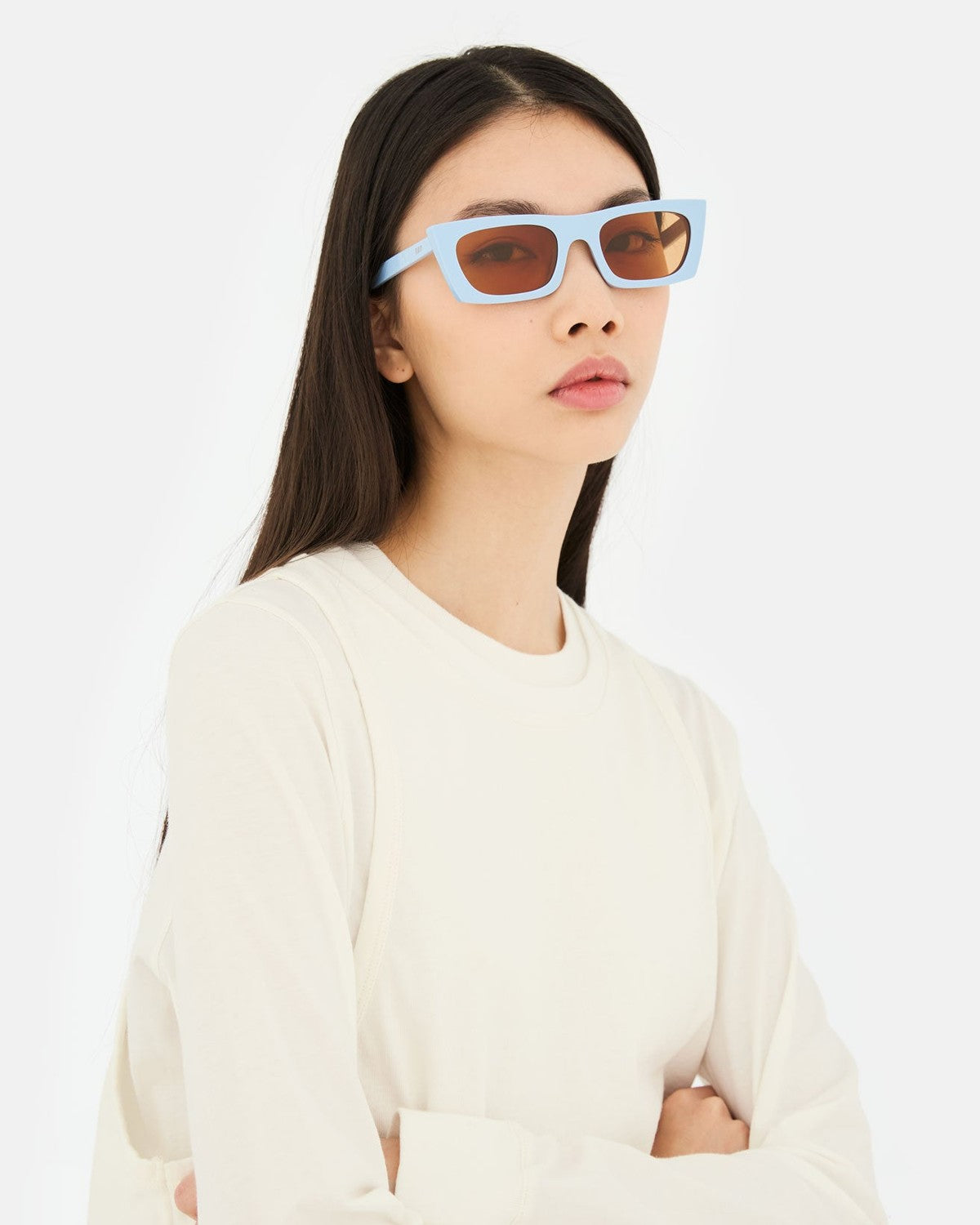 Model wearing RETROSUPERFUTURE Fred 2.0 Coolcat sunglasses with a white top.