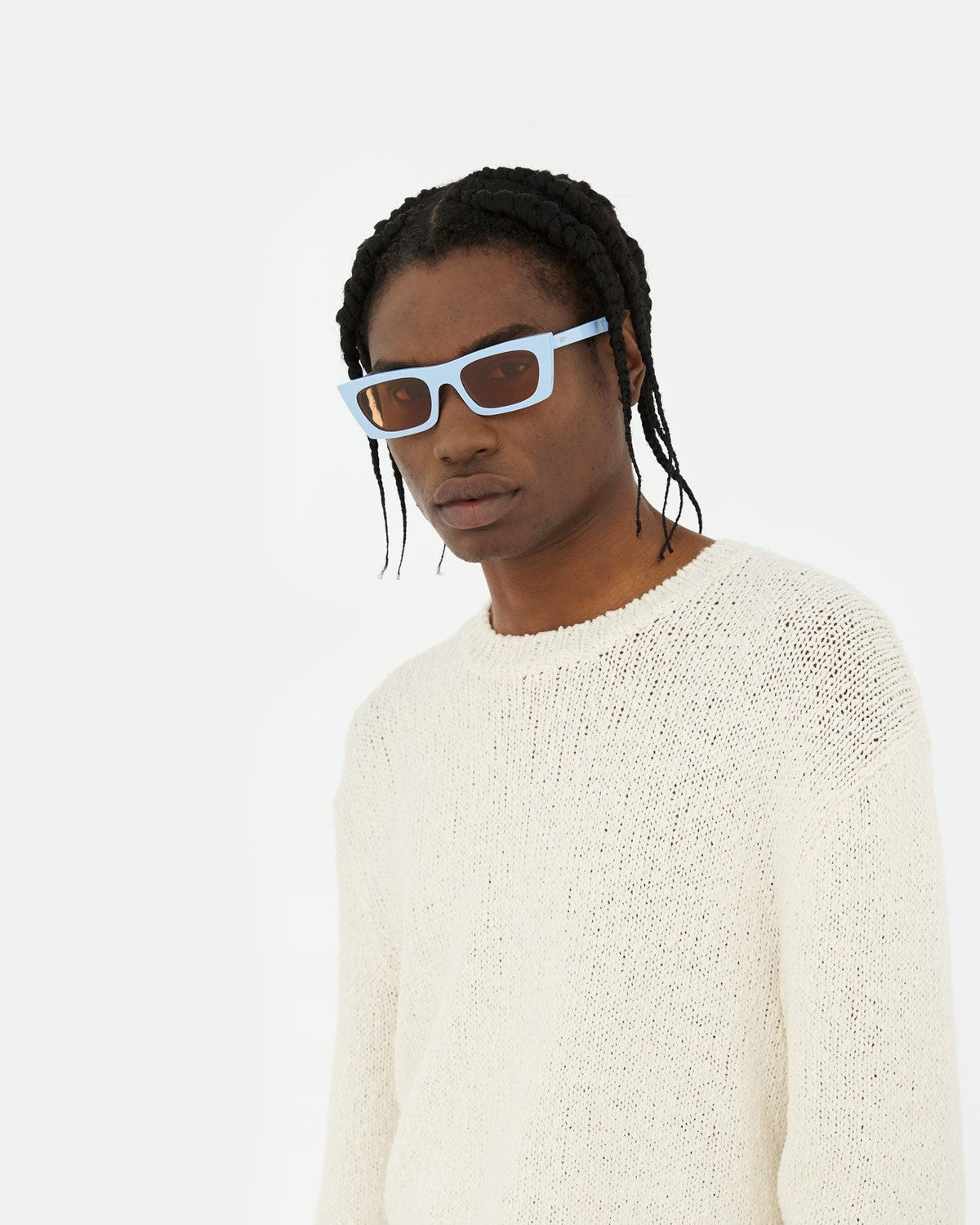 Model in a cream knit sweater wearing RETROSUPERFUTURE Fred 2.0 Coolcat sunglasses.