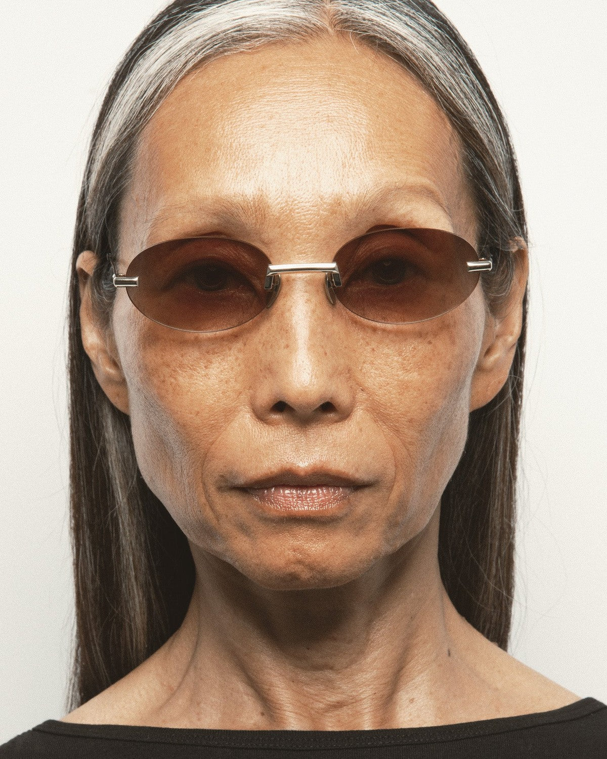 Model wearing KALEOS Fuentes Gold Brown Gradient sunglasses.