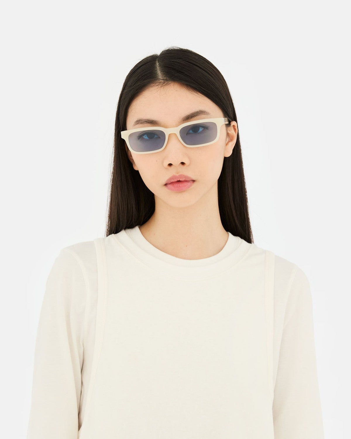 Model wearing RETROSUPERFUTURE Gesto Cremoso sunglasses with long straight hair.