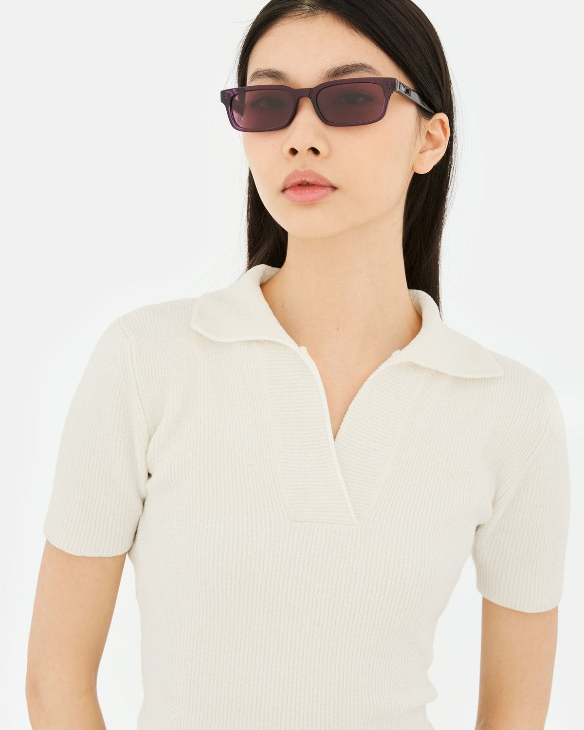 Model wearing RETROSUPERFUTURE Gesto Melanzana sunglasses with white polo shirt.