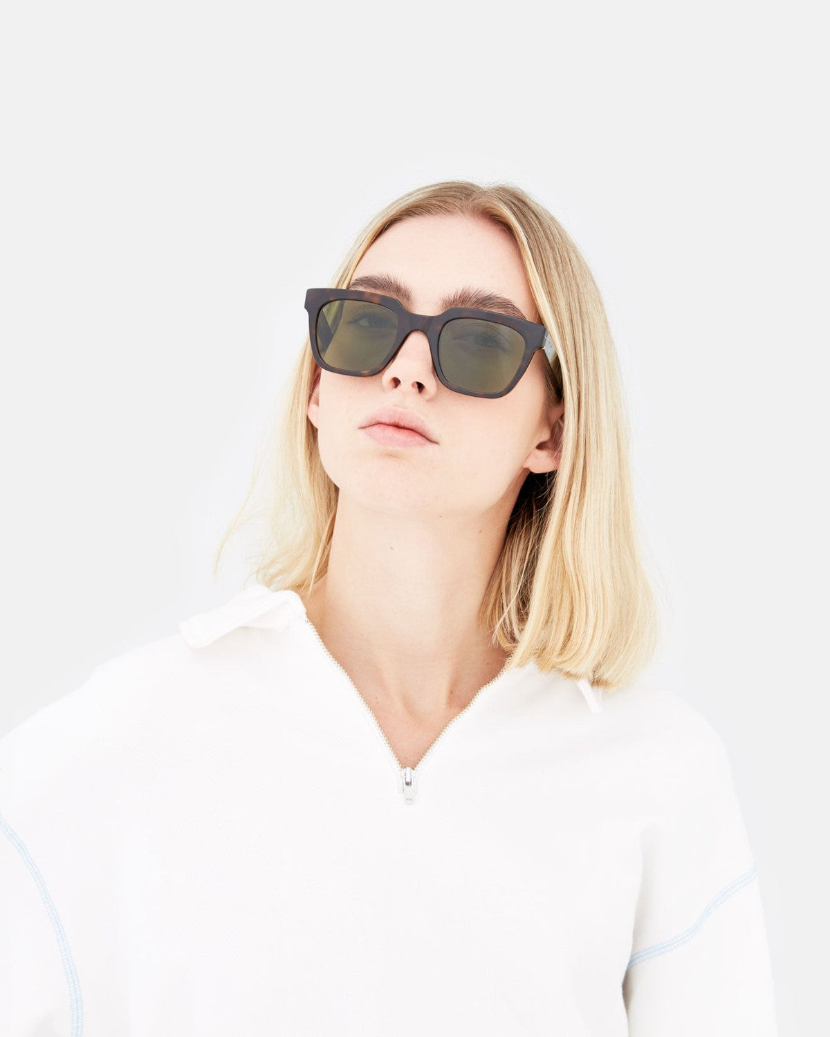 Model in white hoodie wearing RETROSUPERFUTURE Giusto 3627 sunglasses, face tilted upward.