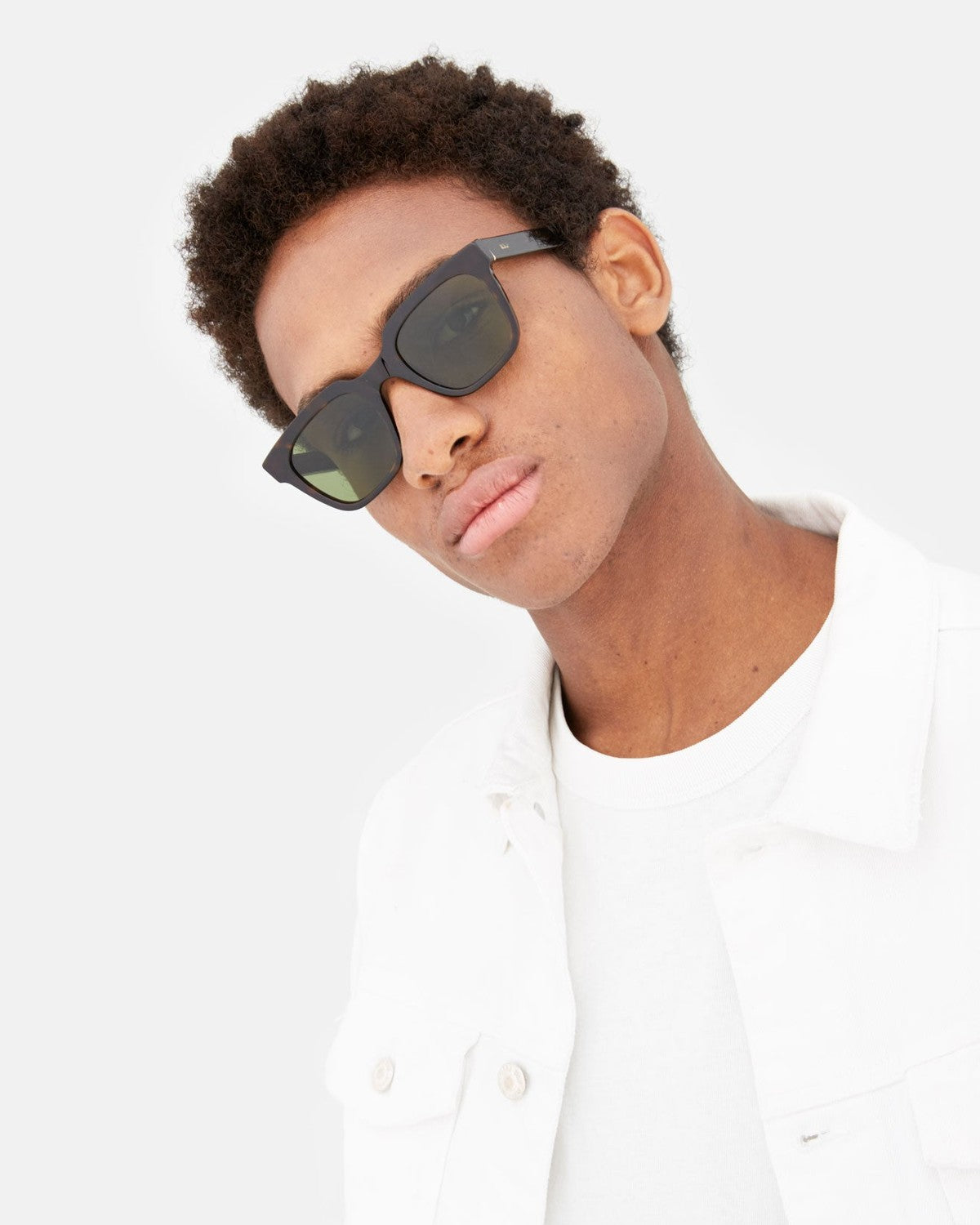 Model in white shirt wearing RETROSUPERFUTURE Giusto 3627 sunglasses, head tilted to the side.