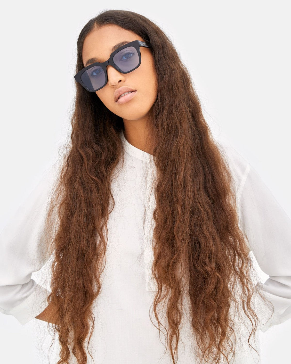Model wearing RETROSUPERFUTURE Giusto Azure sunglasses, looking upward.