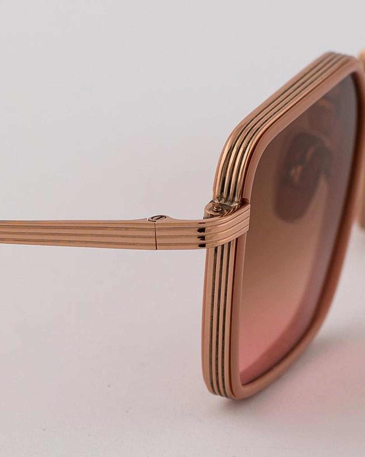 Close-up of the ridged temple and hinge detail on EYEPETIZER GLIDE C.Q-9-44 sunglasses.