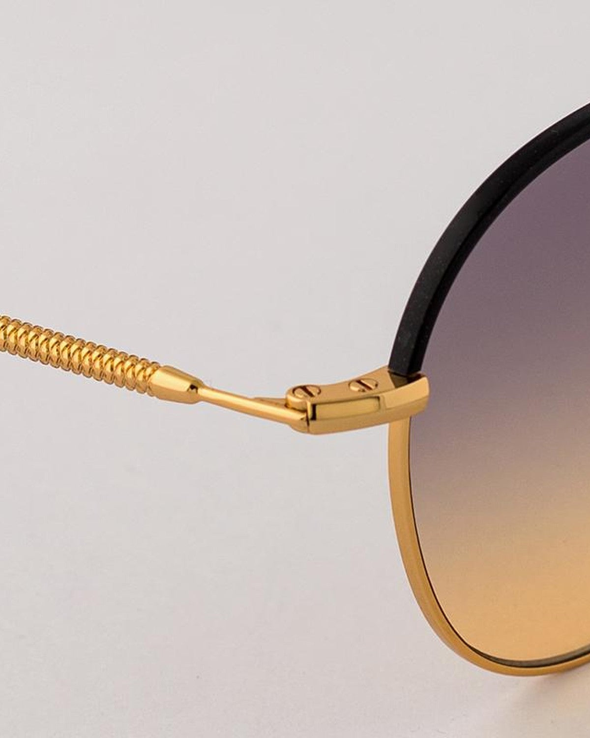 Close-up of the coiled temple and hinge on EYEPETIZER GOBI C.4-A-19 sunglasses.