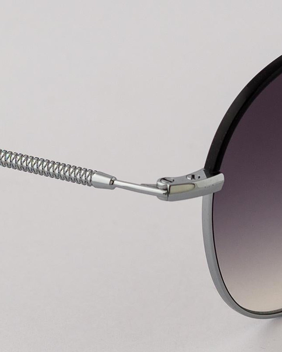 Close-up of the coiled metal temple and hinge on EYEPETIZER GOBI C.1-A-27 sunglasses.
