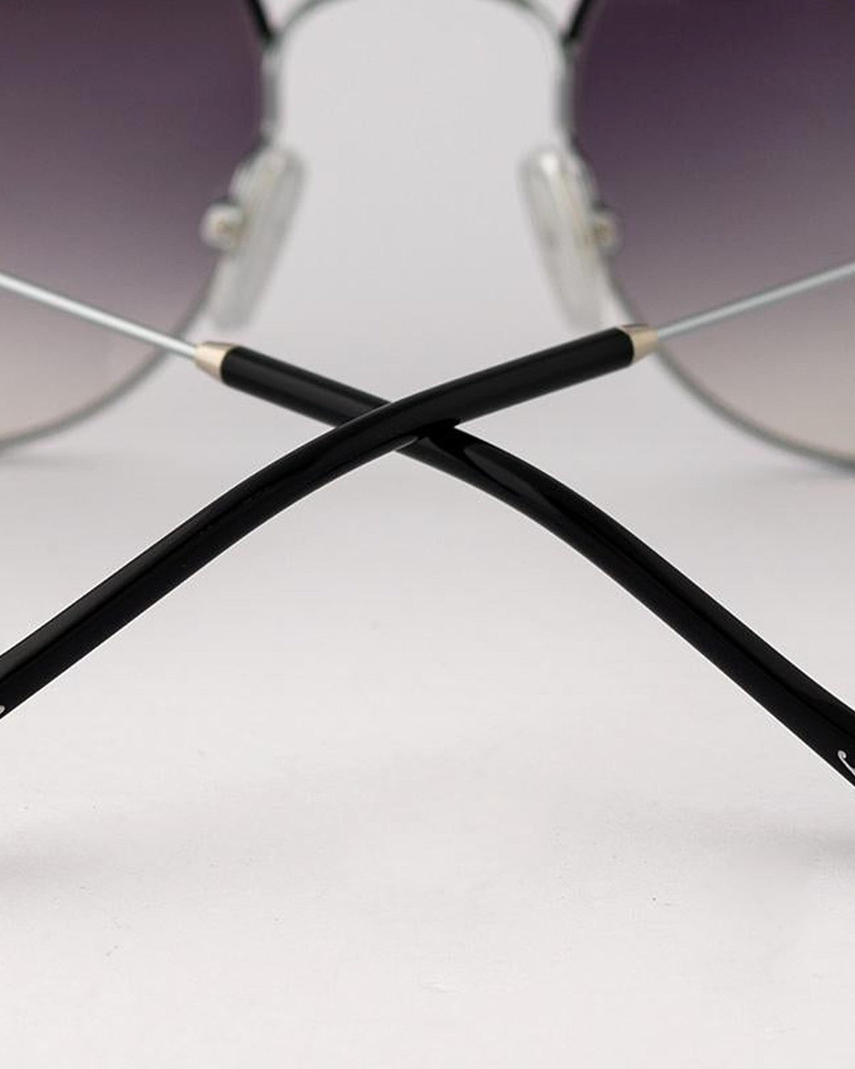 Detail of crossed black temple tips on EYEPETIZER GOBI C.1-A-27 sunglasses.