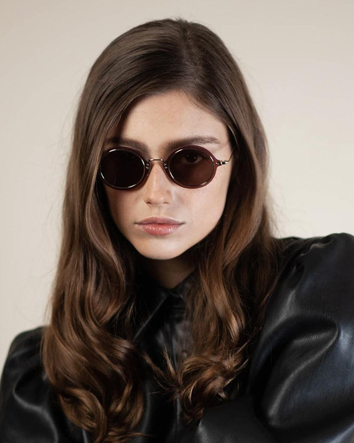 Model wearing EYEPETIZER HUXLEY C.I-2-8 sunglasses with long hair and black leather jacket.