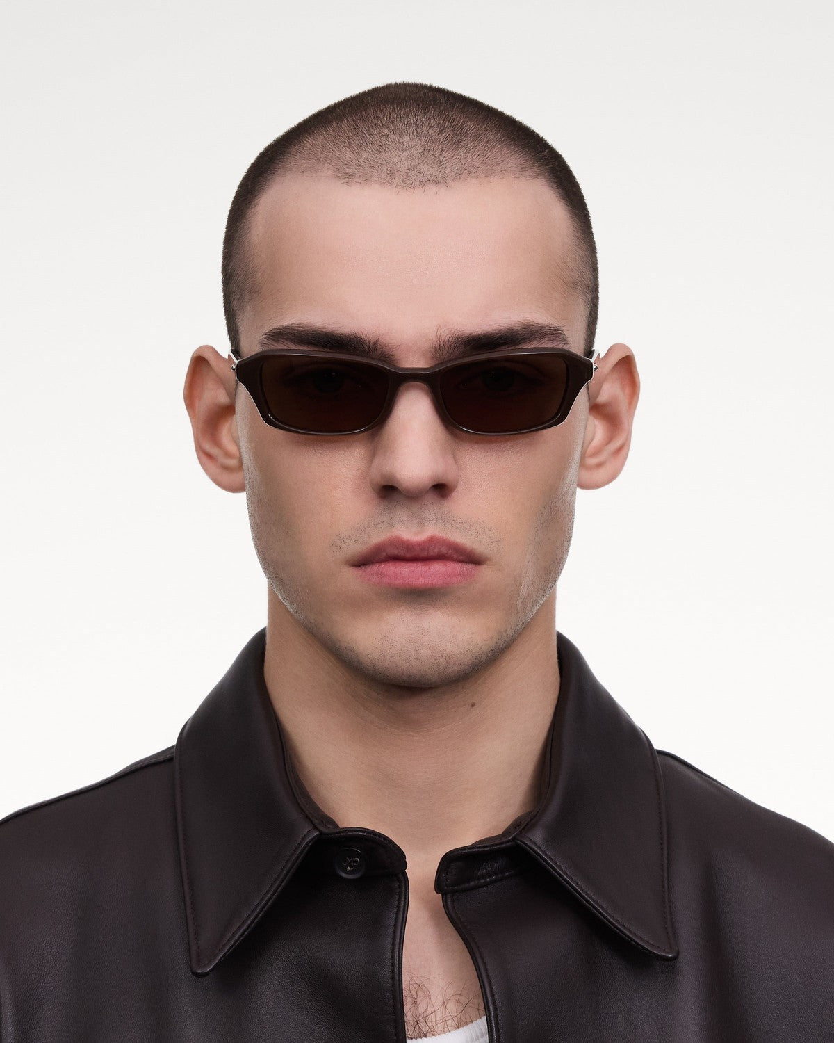 Model wearing CHIMI Iris Brown Brown sunglasses, front view.