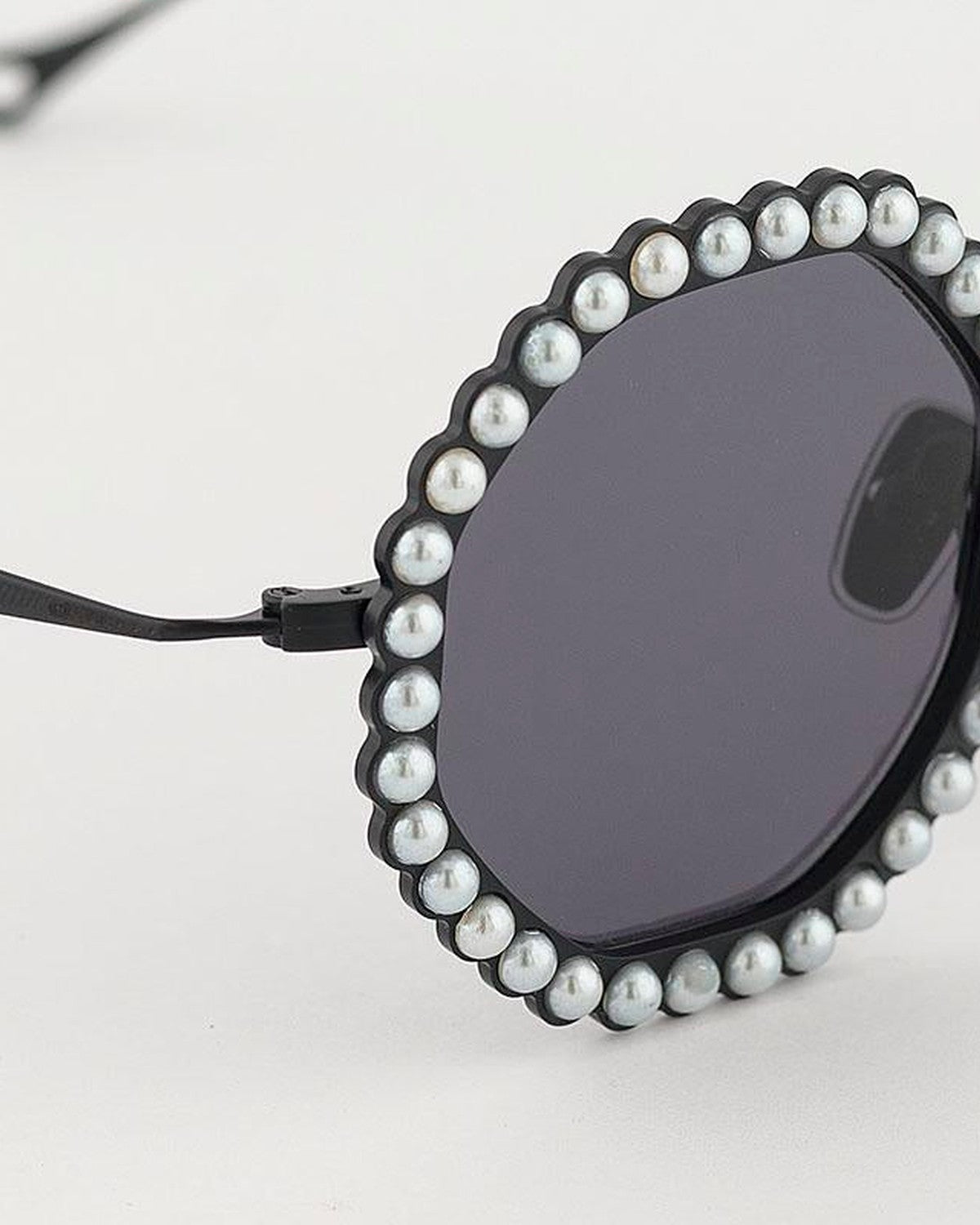 Close-up of the pearl detailing around the lens of EYEPETIZER JORDAN C.6-7 sunglasses.