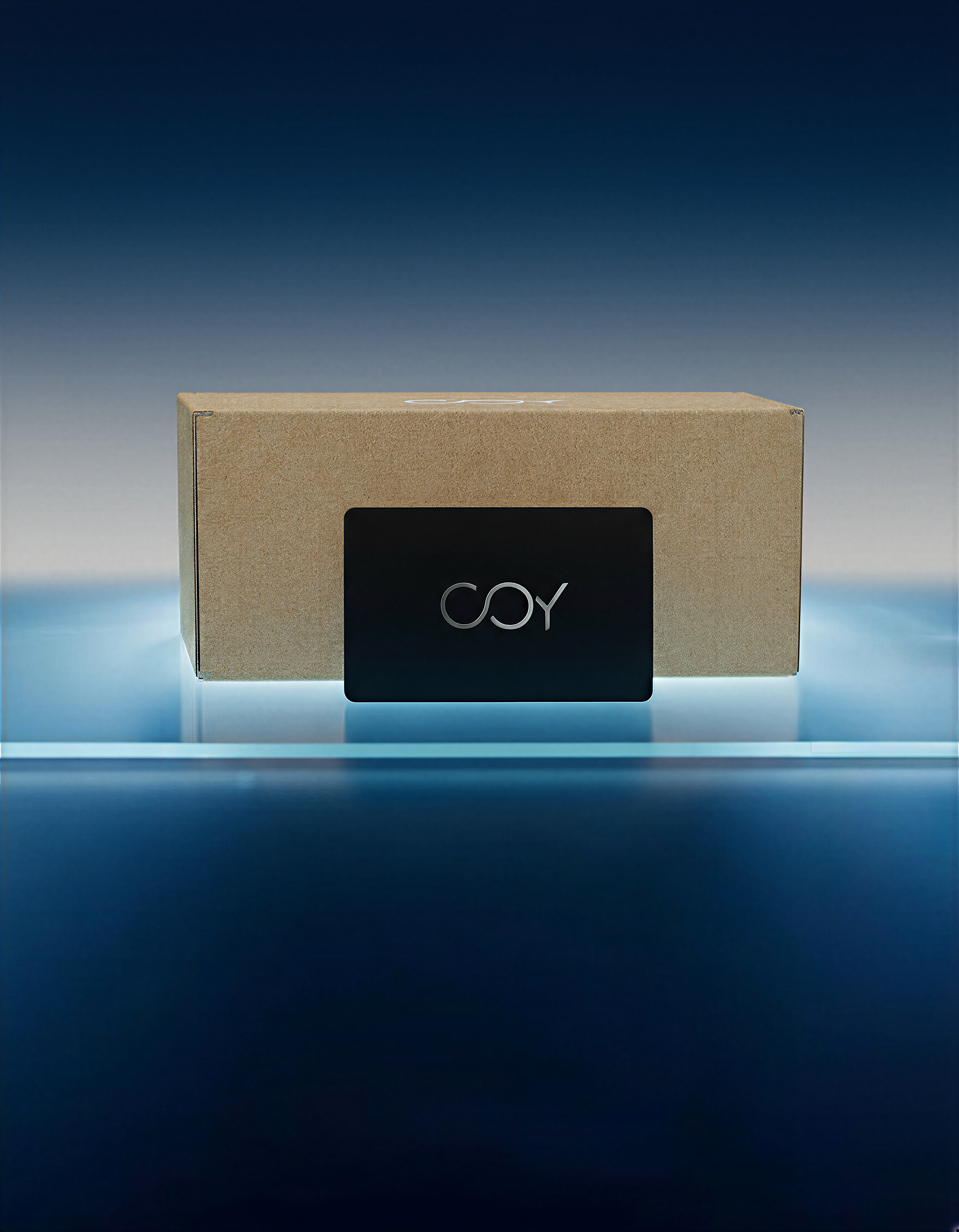 Black card with 'COY' logo on a cardboard box against a gradient blue background