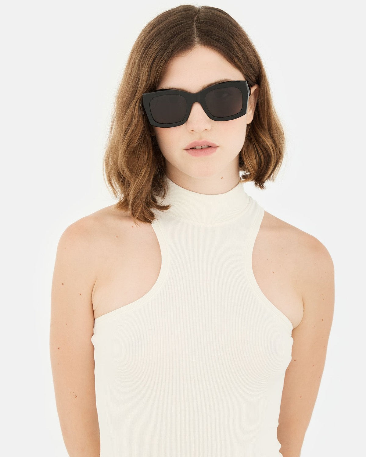 Model wearing RETROSUPERFUTURE Komori Black sunglasses.