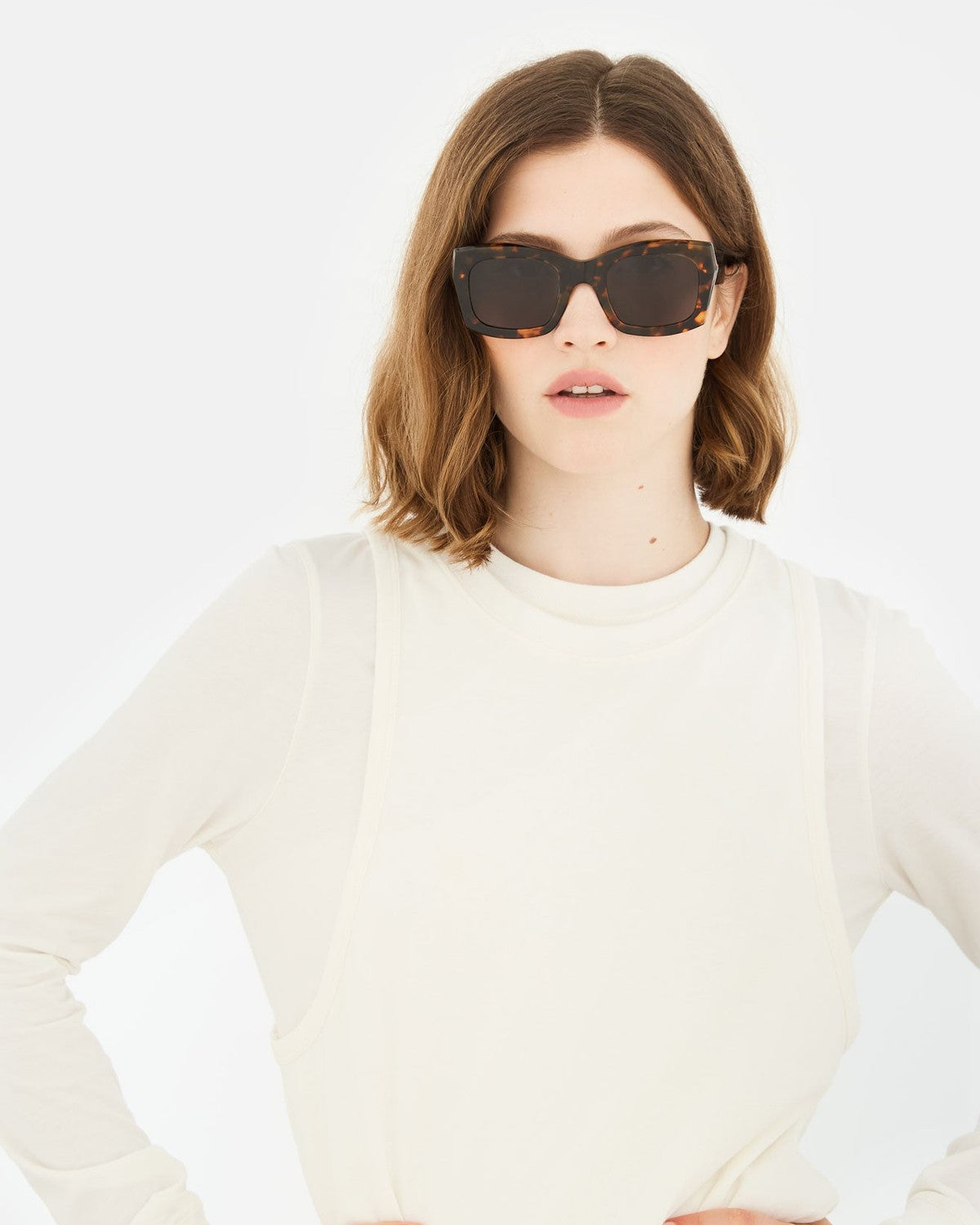 Woman wearing RETROSUPERFUTURE Komori Burnt Havana sunglasses.