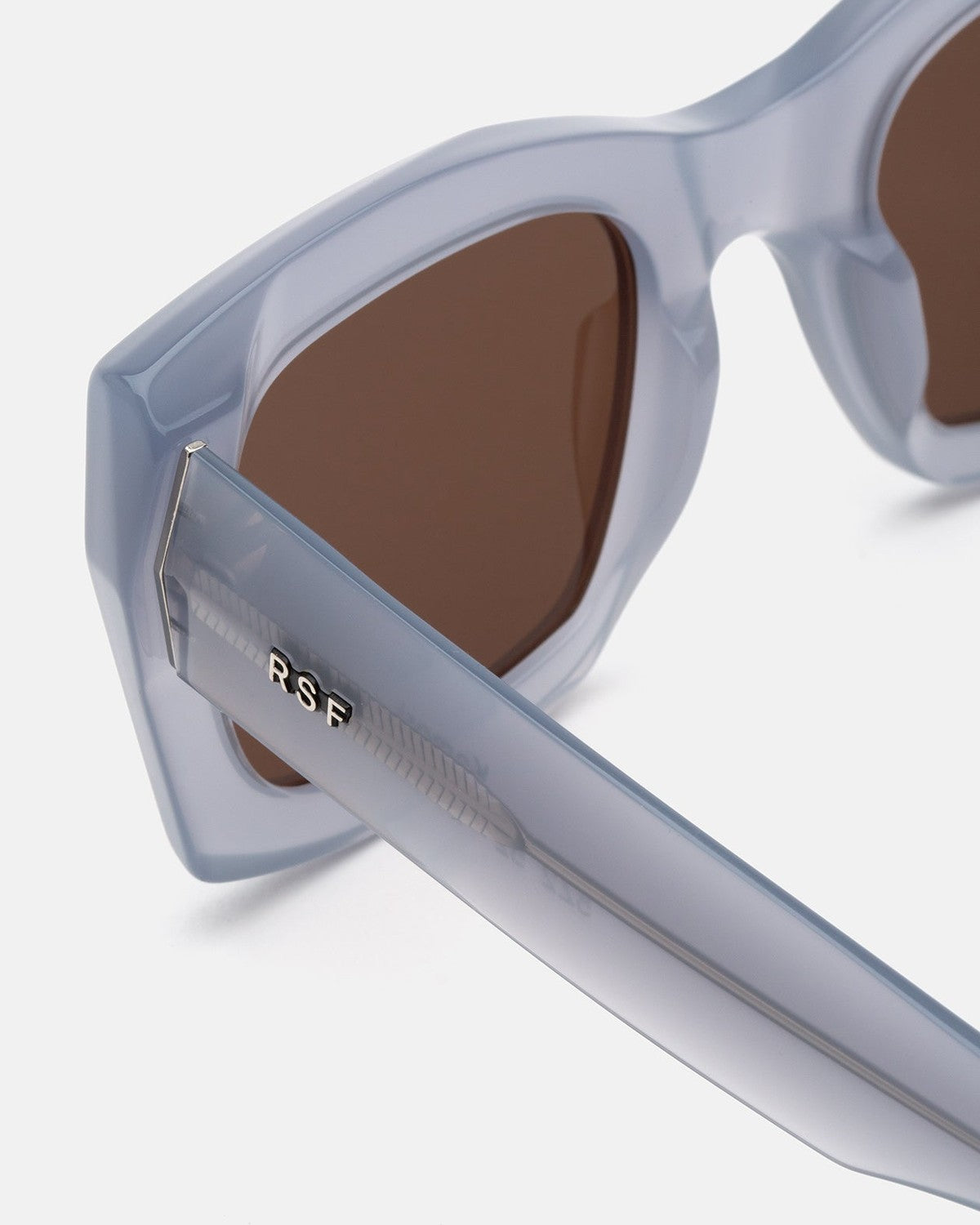 Detail of the temple and hinge on RETROSUPERFUTURE Komori Light Blue sunglasses.