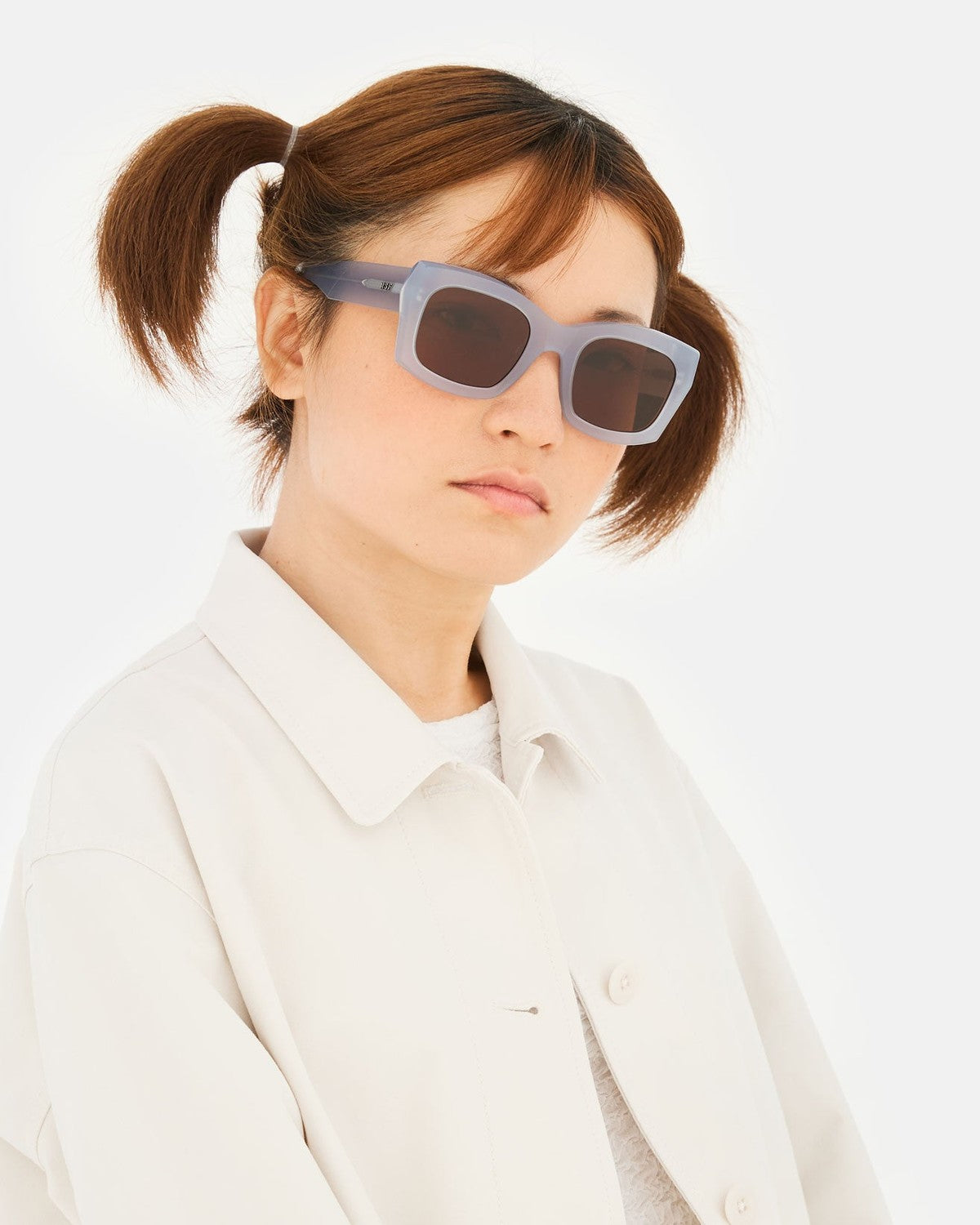 Model wearing RETROSUPERFUTURE Komori Light Blue sunglasses in angled pose.