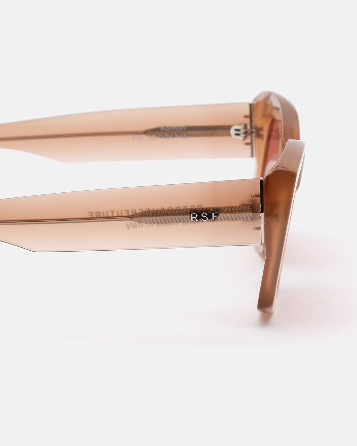 Close-up of the temple arms showing R.S.F. branding on RETROSUPERFUTURE Komori Light Brown sunglasses.