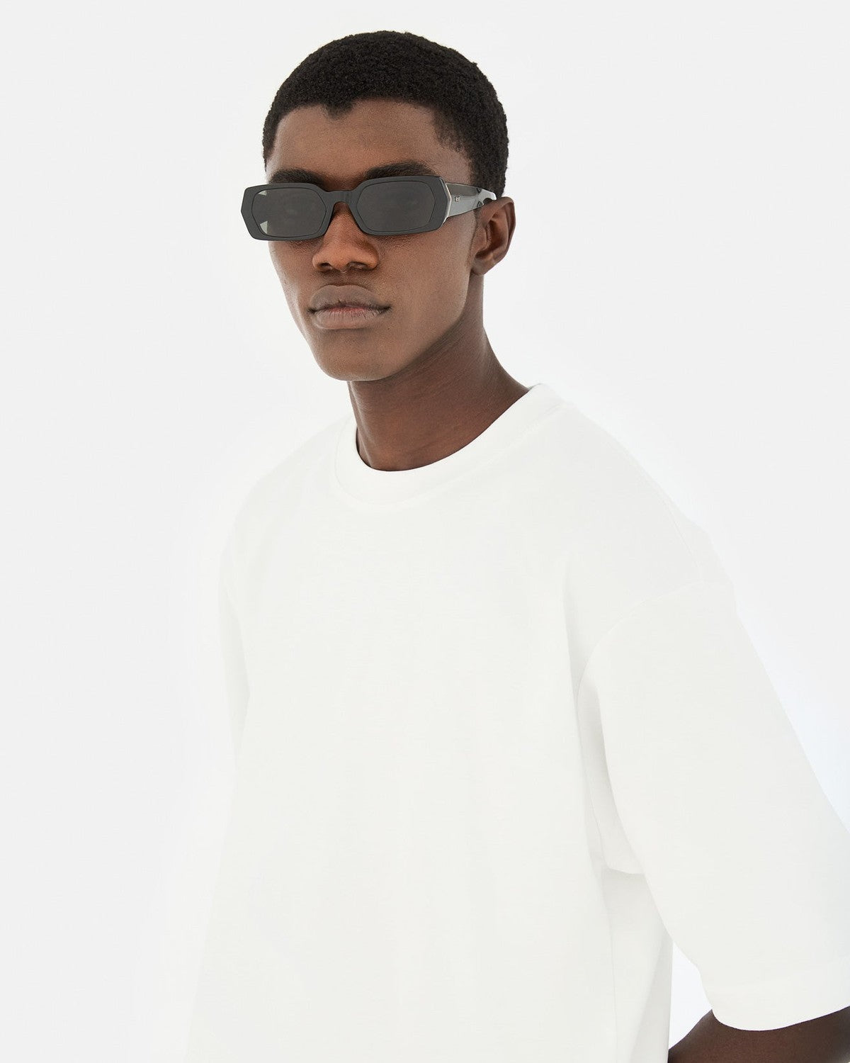 Model wearing RETROSUPERFUTURE L'Altro Black sunglasses.