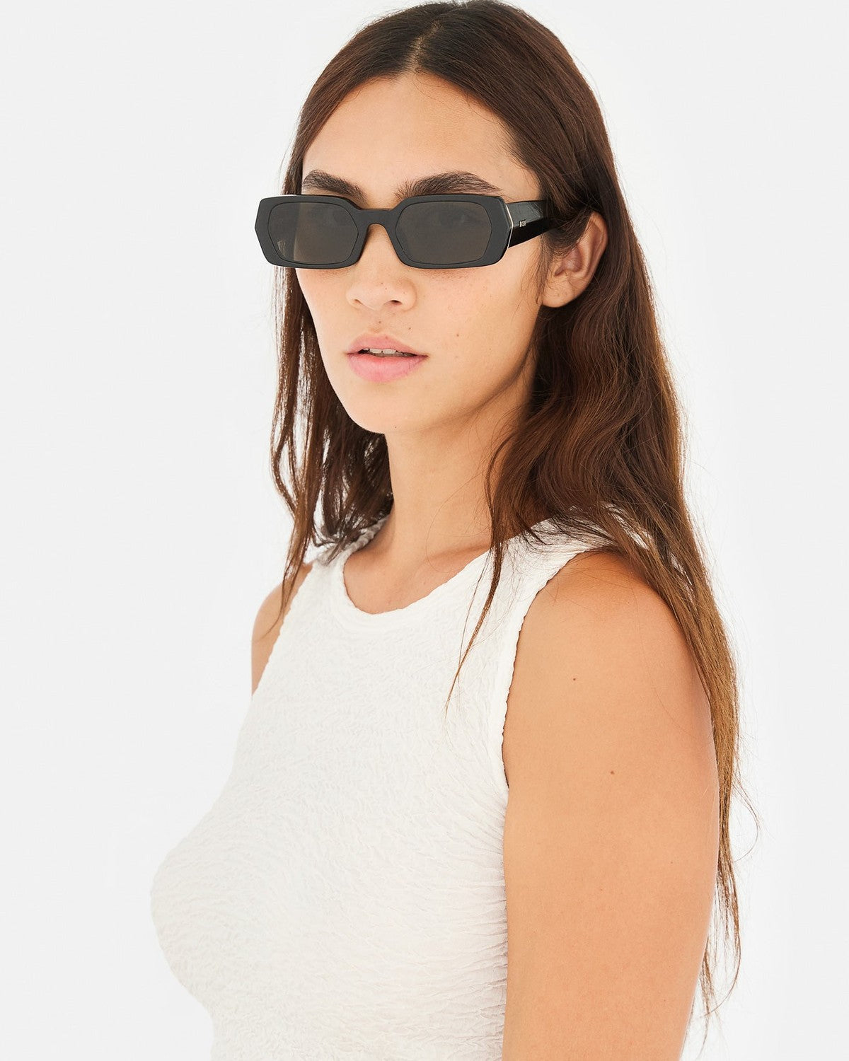 Model wearing RETROSUPERFUTURE L'Altro Black sunglasses in profile.