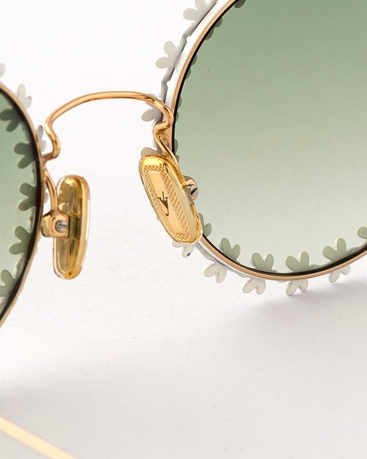 Detail of the engraved logo plaque and temple hinge on EYEPETIZER LULU' C.4/16-31 sunglasses.