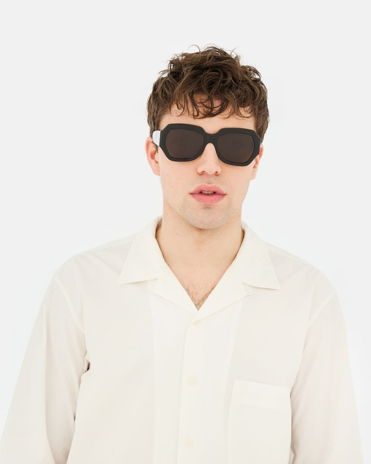 Model wearing RETROSUPERFUTURE Nala Black sunglasses, front view.