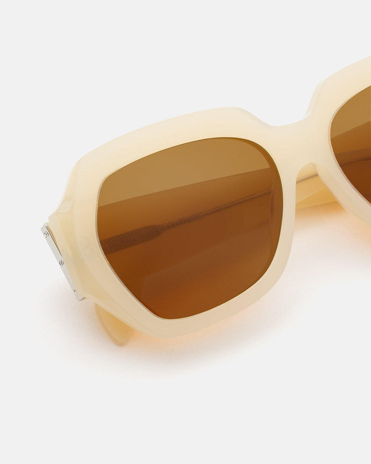 Close-up of the temple hinge on RETROSUPERFUTURE Nala Cremoso sunglasses.