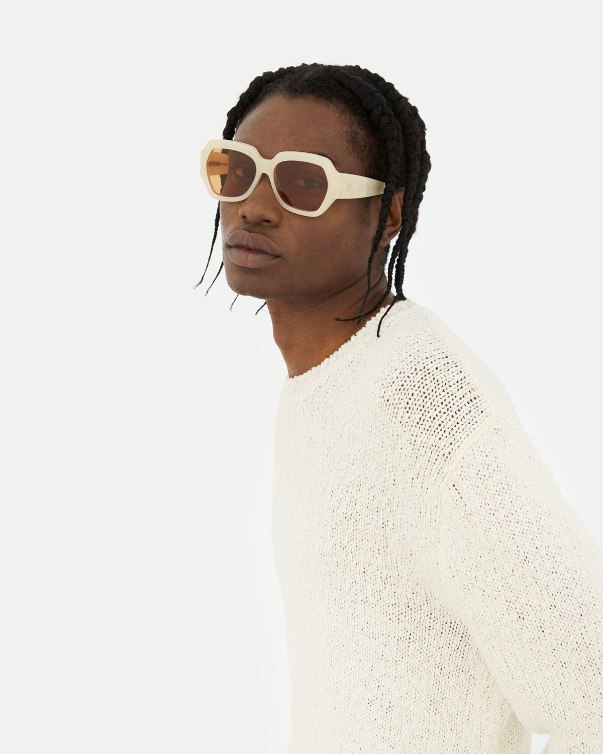 Model wearing RETROSUPERFUTURE Nala Cremoso sunglasses in a knit sweater.