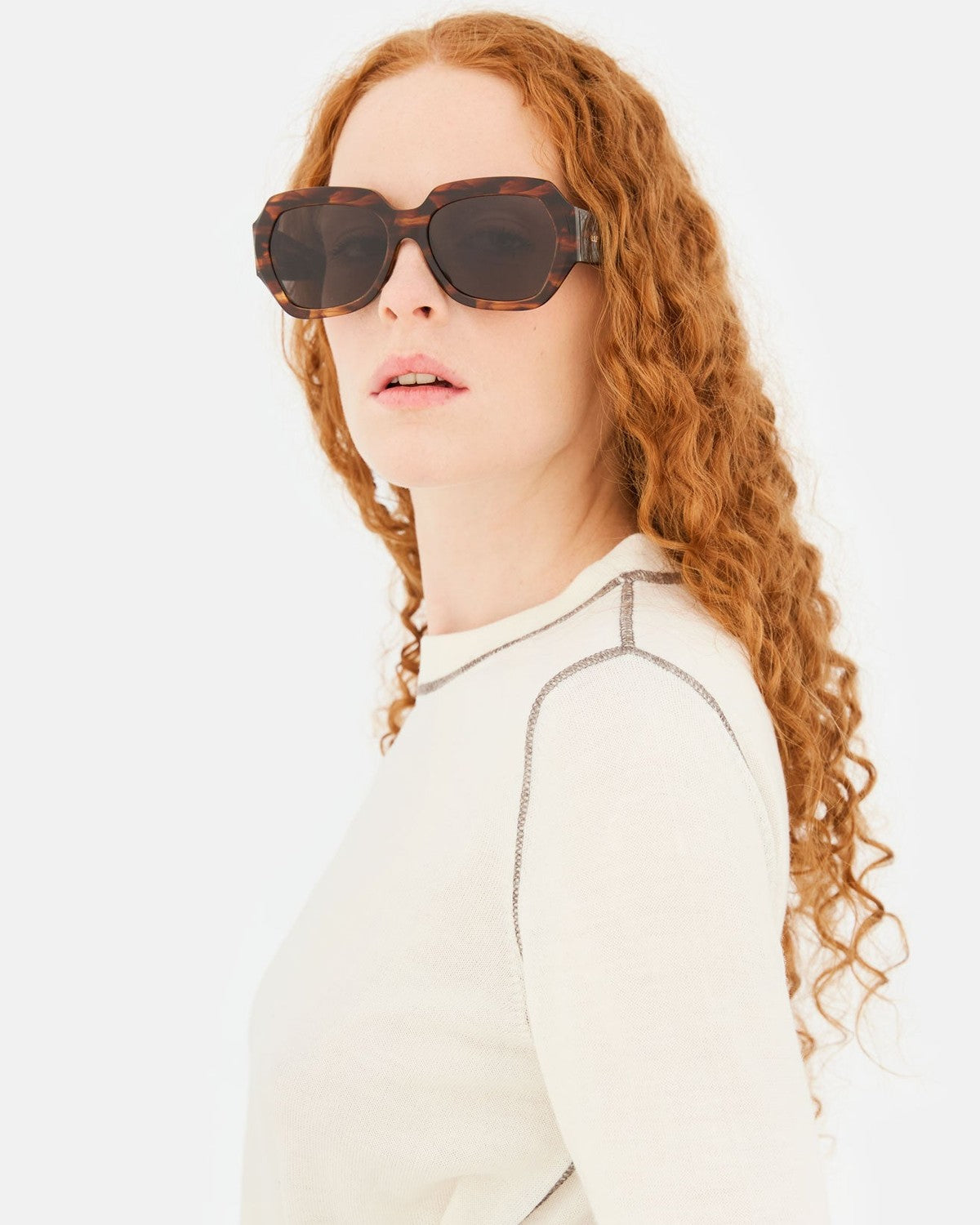 Model wearing RETROSUPERFUTURE Nala Havana Striata sunglasses, angle view.