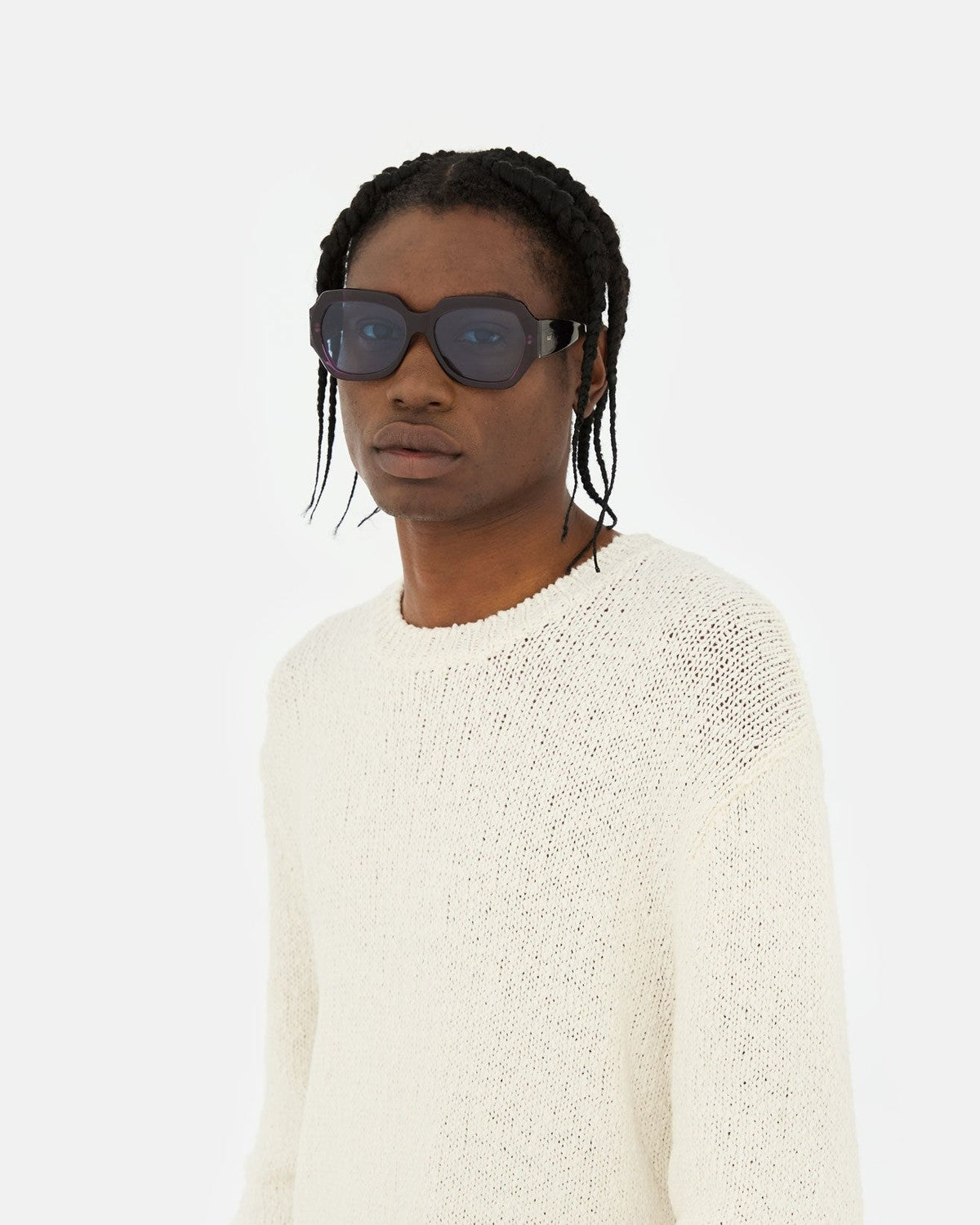 Model wearing RETROSUPERFUTURE Nala Melanzana sunglasses in casual knitwear.