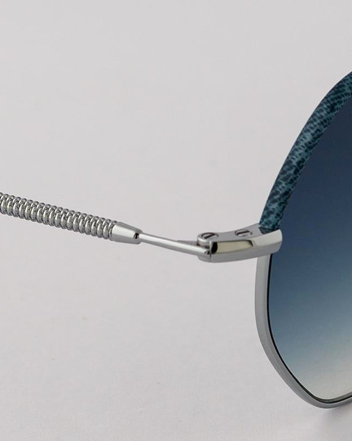 Close-up of the spiral cable temple and hinge attachment on EYEPETIZER NAMIB C.1-R-26 sunglasses.